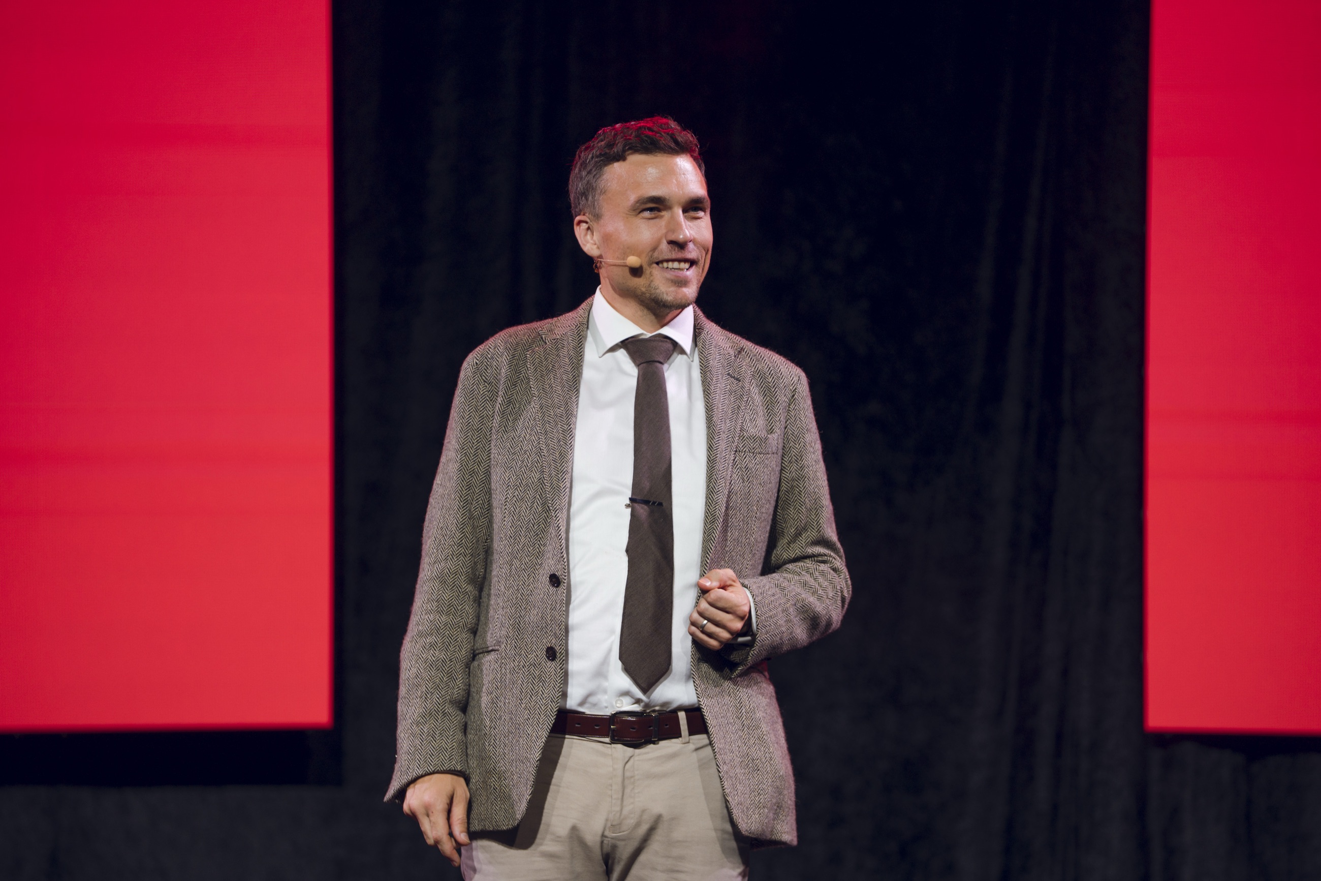 Andy Nunn presenting on stage at a KFC corporate event